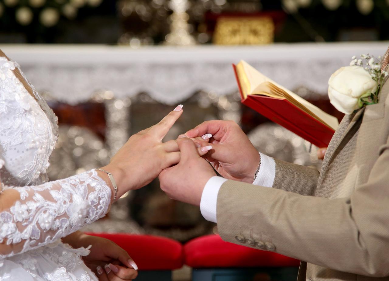 pareja que se pone los anillos en la iglesia