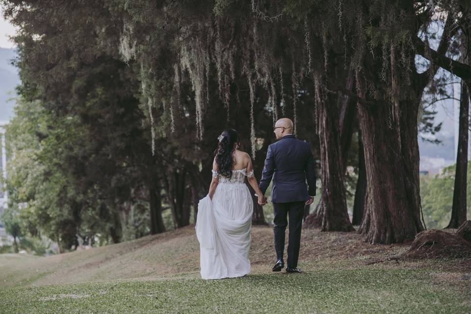 novios caminando por bosque después de la boda