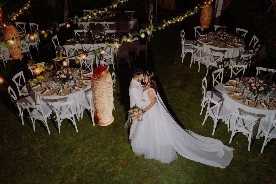 Novios besándose en el jardín del evento